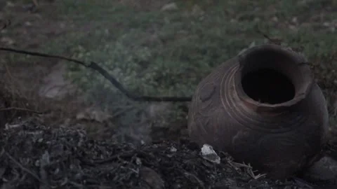 Burned Clay Pot in Fire Ash Close-Up Stock-Footage 332611919