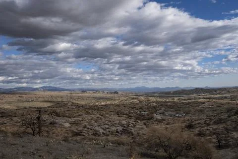 Burned desert with cloudy sky Stock Photos