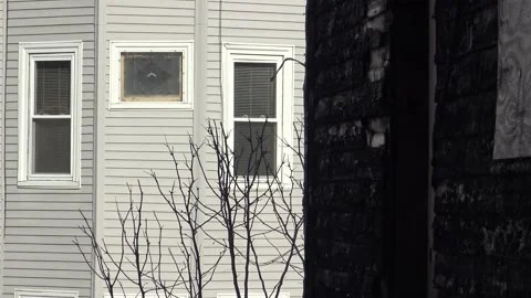 Burned down house next to white house contrast Stock Footage 143081968