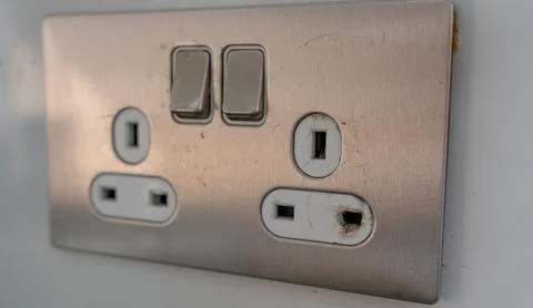 Burned electrical power socket, unsafe wall power socket 写真素材