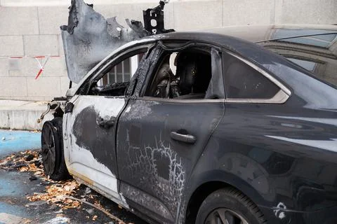 Burned expensive black car with mangled hood Stock Photos