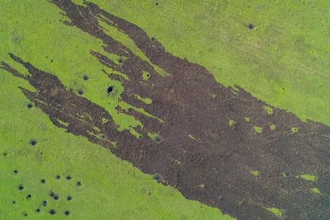 Burned field pattern after missile strike, charred earth and scorched Stock Photos