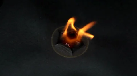 Burned hole on  black paper background Stock Footage 36437260