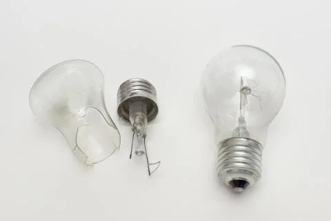 Burned out bulb near the split in half incandescent lamp Stock Photos