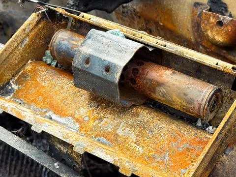 Burned steering column lock from a car with heavy rust and fire damage, sho.. Stock Photos