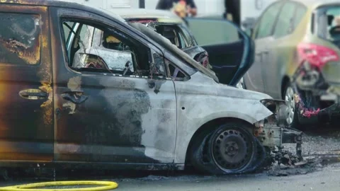 Burned van with charred doors and destroyed front end after vehicle fire. Fire Stock Footage 345501104