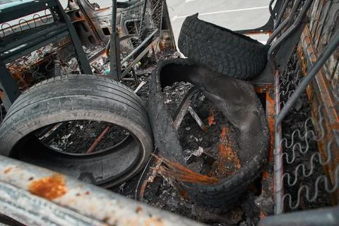 Burned Wheel and Melted Exploded Rubber Tire inside Van Shell Stock Photos