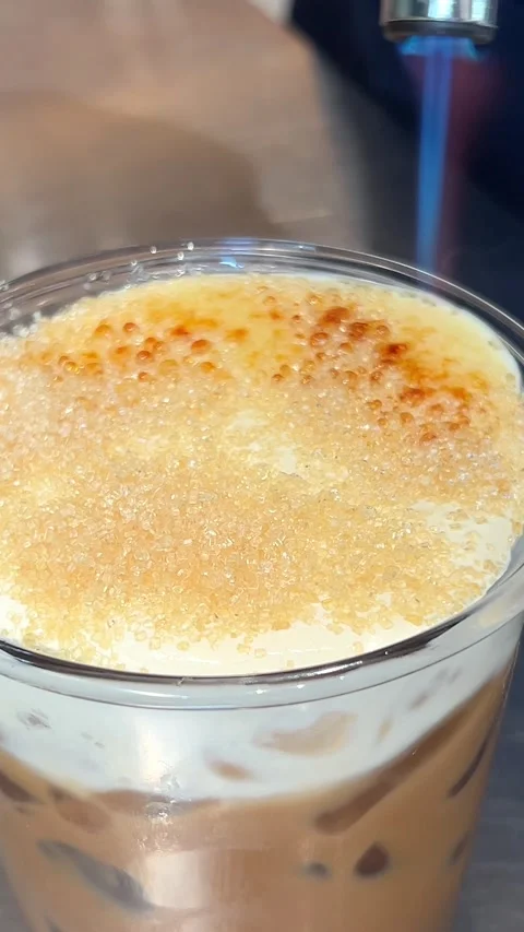 Burner burn sugar cake Caramelizing sugar on top of creme brulee dessert with a Stock Footage 277267342