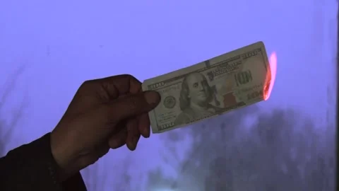 A burning $100 bill on a person's hands. Stock Footage 219346005