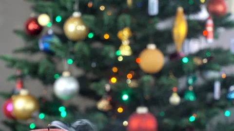 Burning and extinguished candle and Christmas lights in 4K Stock Footage 140048888