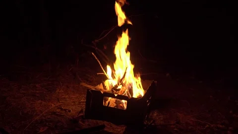 Burning ash rise from large fire in brazier in black background. Stock Footage 139651303