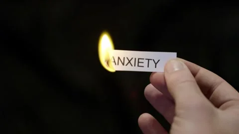 Burning Away Anxiety - Hand Setting Fire to Paper note Marked “ANXIETY” Stock Footage 332378782