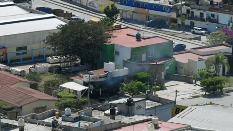Burning bank captured after reported cartel retaliation in Tuxpan, aeril view Stock Footage 331147282