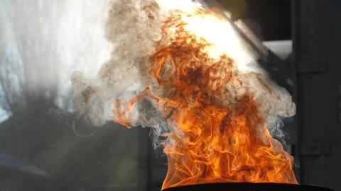 A burning barrel with fire against the background of buildings on a bright sunny Stock Footage 169570251