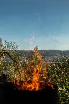 Burning barrel in the middle of the garden Stock Photos