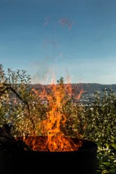 Burning barrel in the middle of the garden Stock Photos