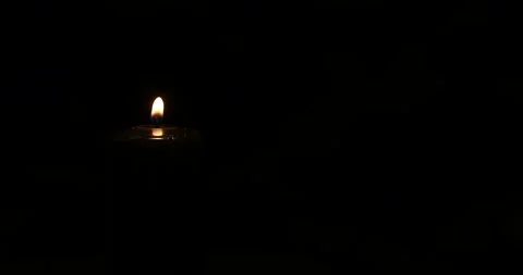 A burning black candle is spinning on a dark background. Close up Stock-Footage 165825768