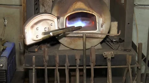 Burning in a blacksmith forge. Making metal items in smithy Stock Footage 102447996
