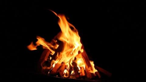 Burning bonfire on a black background with bright erupting sparks. Natural Stock Footage 147960688