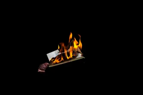 Burning book on a black background Stock Photos
