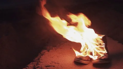 Burning boots on the sand at coast strong bright flame summer dark night Stock Footage