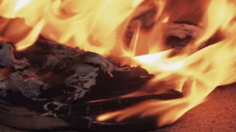 Burning boots on the sand at coast strong bright flame summer dark night Stock Footage