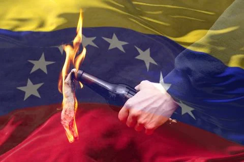A burning bottle with fire in the hand of a man on the background of the flag Stock Photos