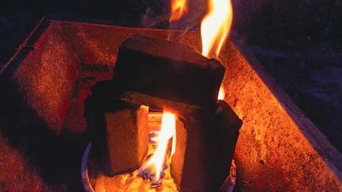 Burning Bricks in Metal Container Stock Photos