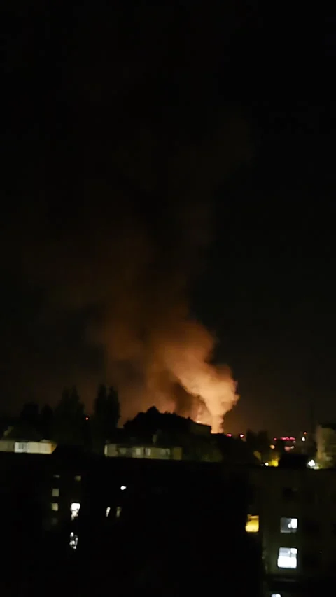Burning building at night after drone strike with smoke and flames Video stock 312415061
