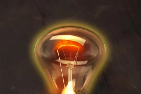 A burning bulb on a black background Stock Photos