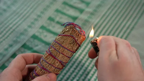 Burning bundle of thin sage leaves - Medium Shot - 4K 120fps Stock Footage 206164773