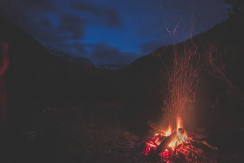 Burning camp fire into remote larch and pine tree woodland with high altitu.. Stock Photos