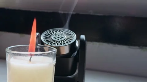 Burning Candle And Aroma Diffuser Emitting Mist Stock Footage 346105589