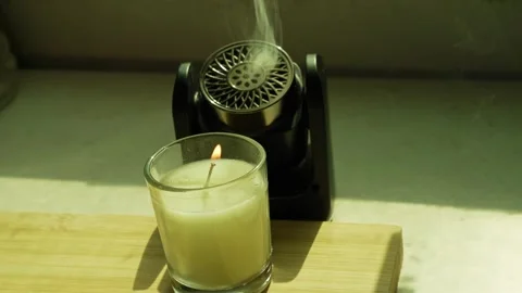 Burning Candle And Aroma Diffuser In Daylight Stock Footage 348154952