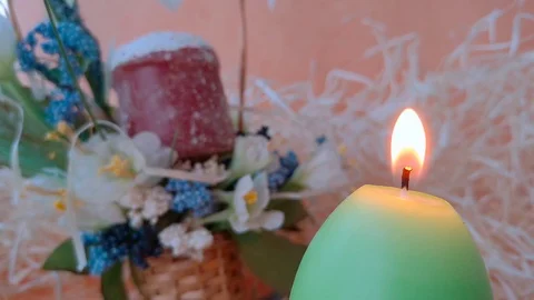 Burning candle and Easter basket with cake and flowers Stock Footage 104672326