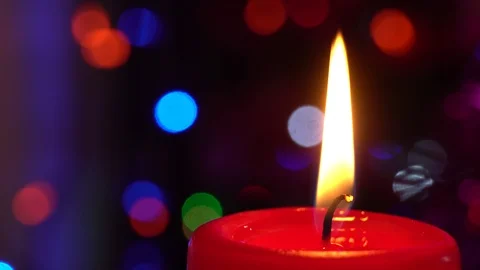 Burning candle on the background of the New Year's garland, fast flickering. Stock Footage 122646820