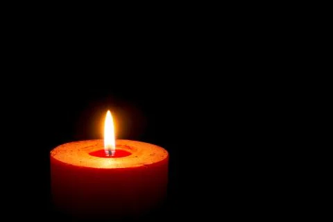 Burning candle on black background Stock Photos