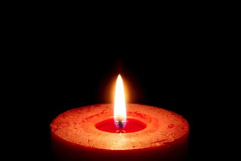 Burning candle on black background Stock Photos