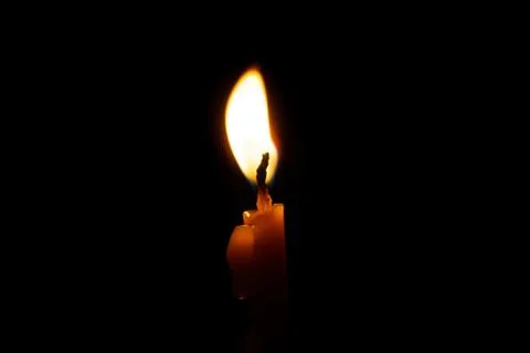 Burning candle on black background Stock Photos