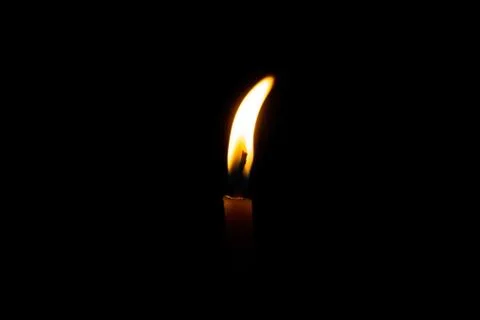 Burning candle on black background Stock Photos