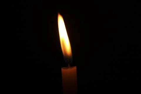 Burning candle on black background Stock Photos