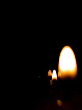 Burning candle on black background Stock Photos