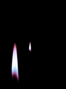 Burning candle on black background Stock Photos