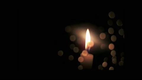 Burning candle, on black background, through glass with bokeh reflections. Stock Footage 237065685