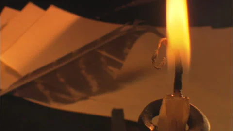 Burning Candle blown out - foreground flame on historical tabletop with papers Stock Footage 144134671