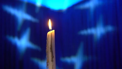 Burning candle with blue curtain background Stock Footage 274366274