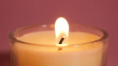 Burning candle close up on a pink background. Stock Footage 148661532