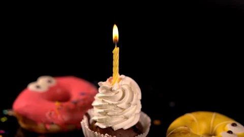 Burning candle on a cupcake being blown out Video stock 96447201