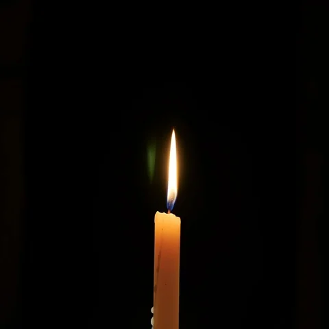 Burning Candle on a Dark Background Stockbeeldmateriaal 69376895