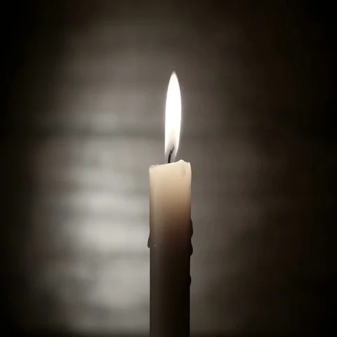 Burning Candle on a Dark Background Stockbeeldmateriaal 69377529